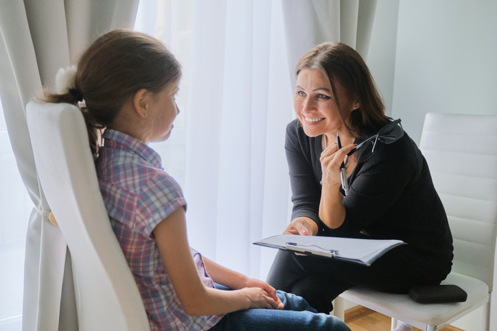 child doing myofunctional therapy with adult